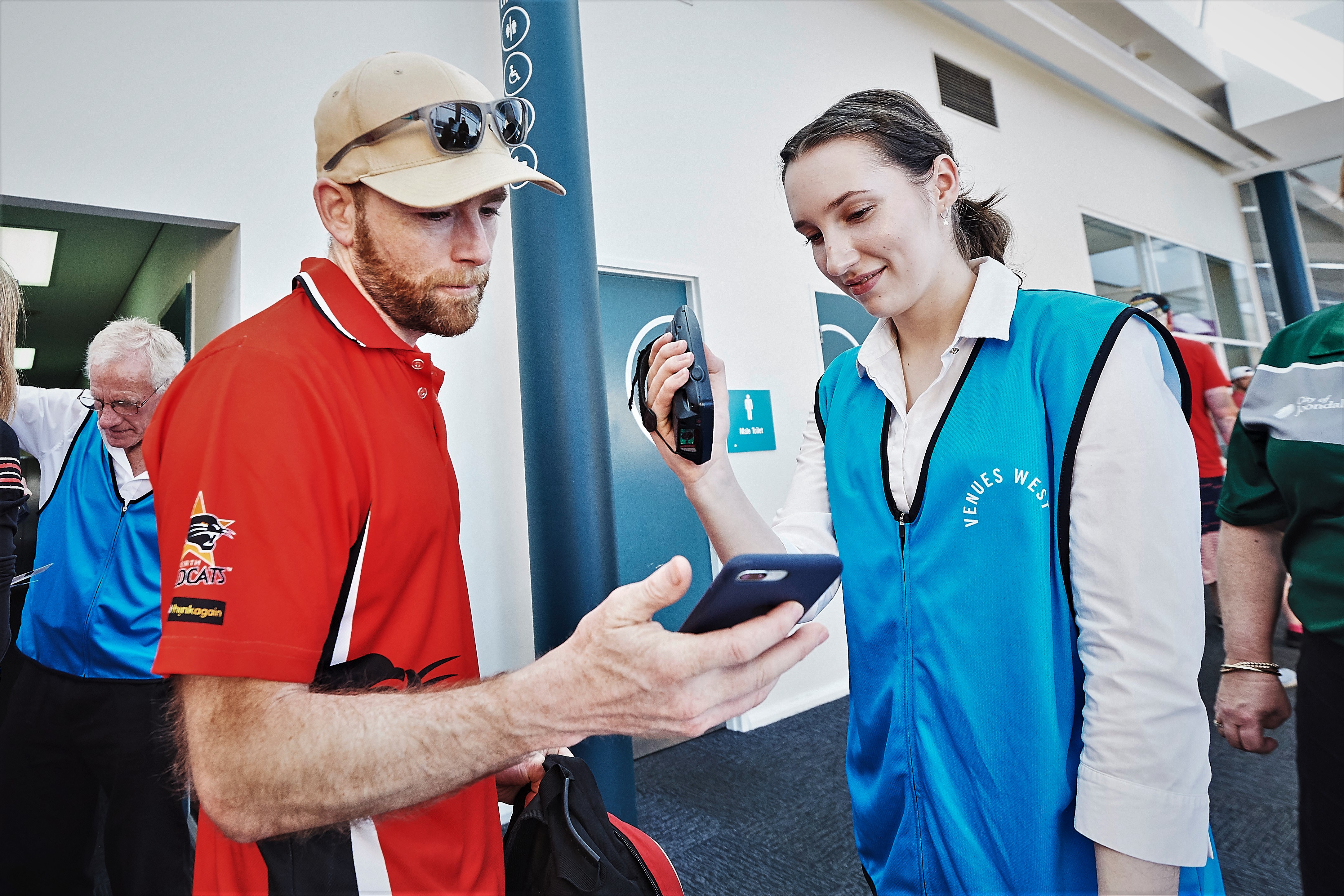 A photo of an event staff member scanning the ticket of a patron