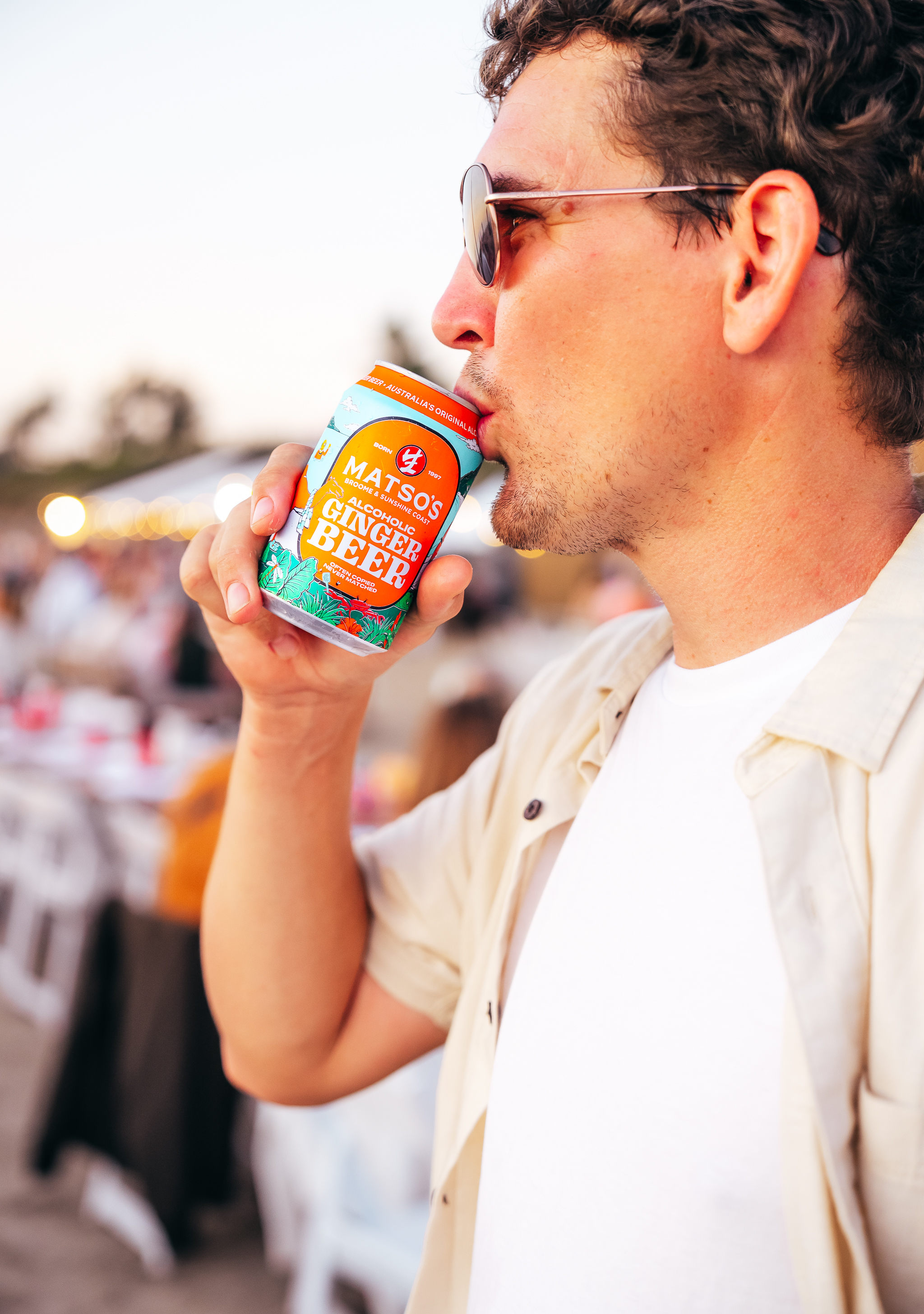 Man drinking from a beer can