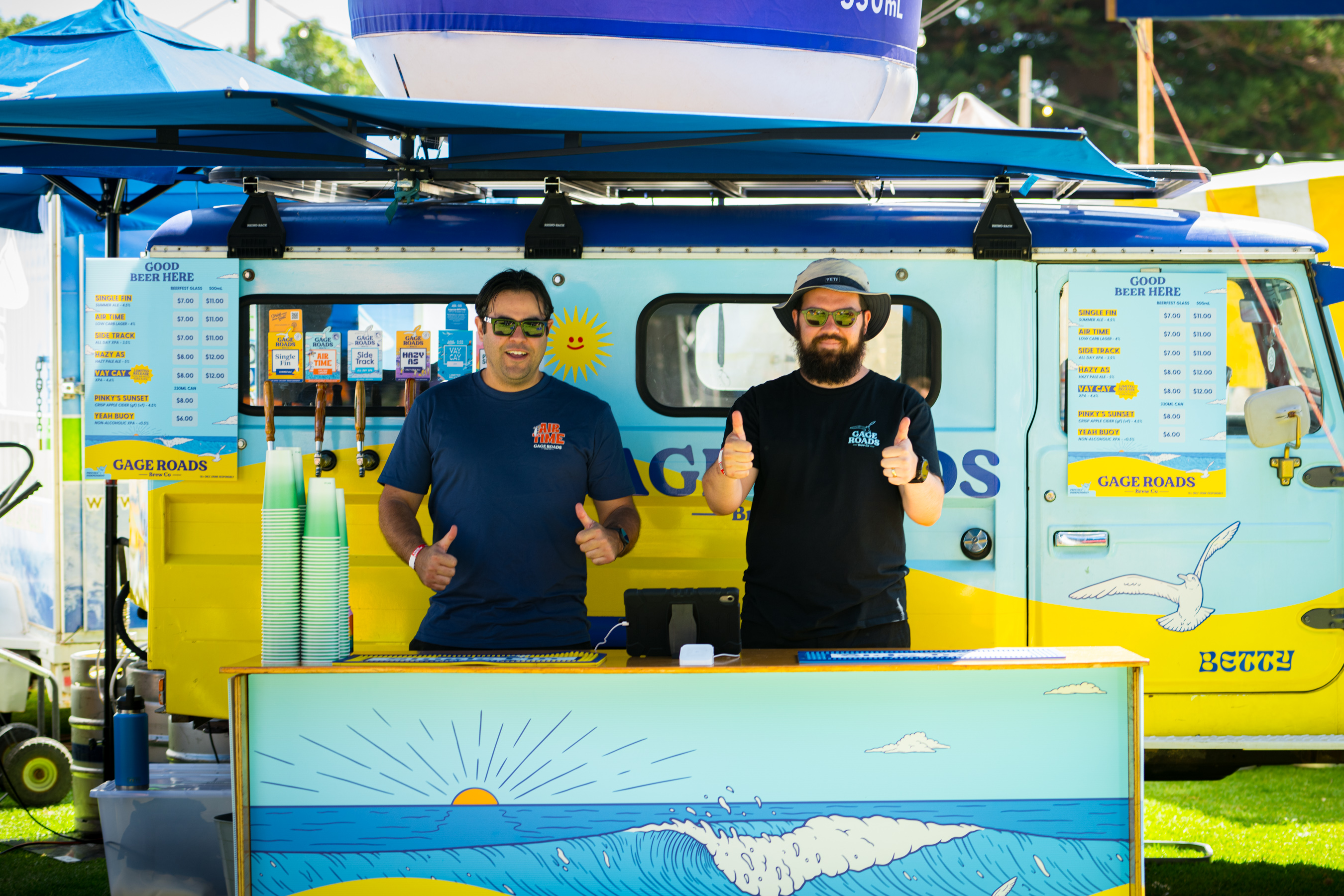 Two vendors standing behind a stall