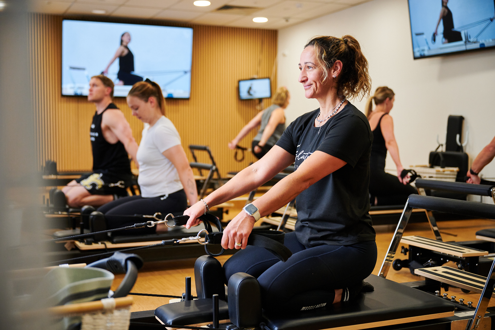 Exercising in a group reformer pilates class at a Perth HPC.