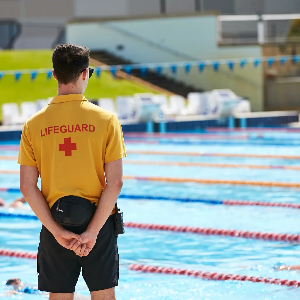 Lifeguard patrolling outdoor pool